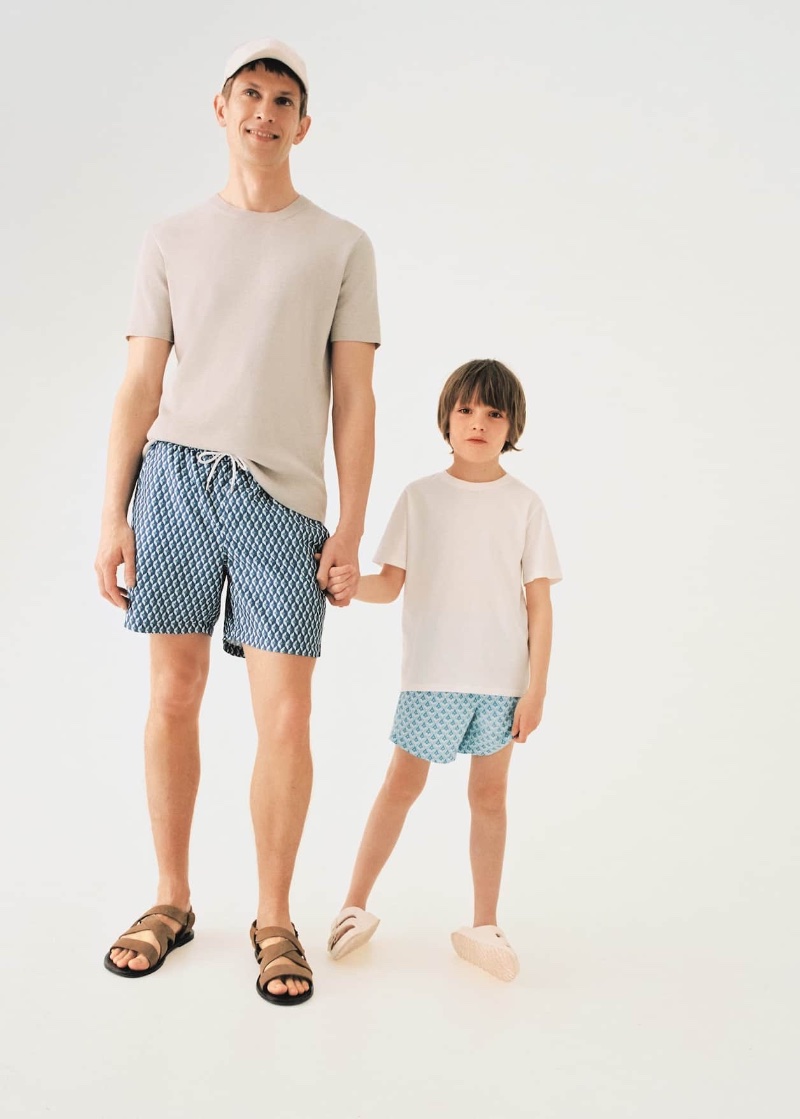 Connecting with Mango for Father's Day, Mathias Lauridsen and his son wear t-shirts and swim shorts.