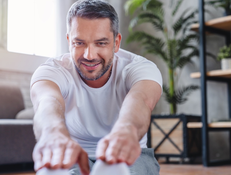 Middle Age Man Stretching Living Room