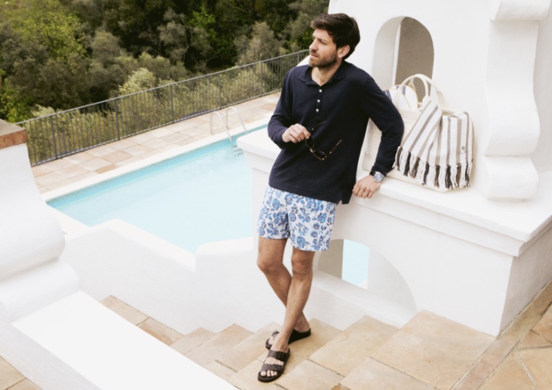 Vincent Banić sports a Massimo Alba polo with Loro Piana swim shorts, Persol sunglasses, and Officine Creative sandals.