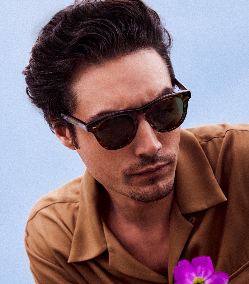 Oliver Peoples enlists Levi Dylan as the star of its summer 2023 campaign where he wears the brand's Rorke sunglasses. 