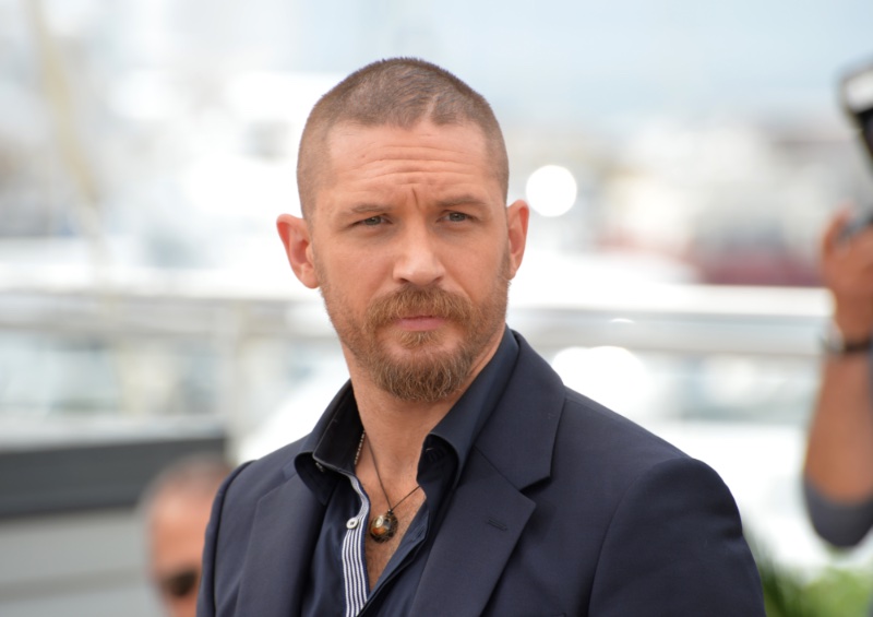 Tom Hardy is distinctive with his trendy buzz cut and beard.