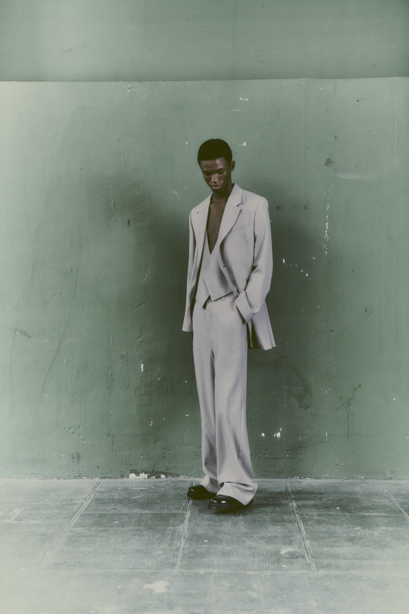 Ayomide Onasanya models a grey three-piece suit from AMI's spring-summer 2024 collection.