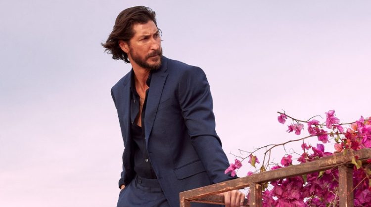 Ryan Porter models a navy suit with a black shirt for Banana Republic's summer 2023 campaign.