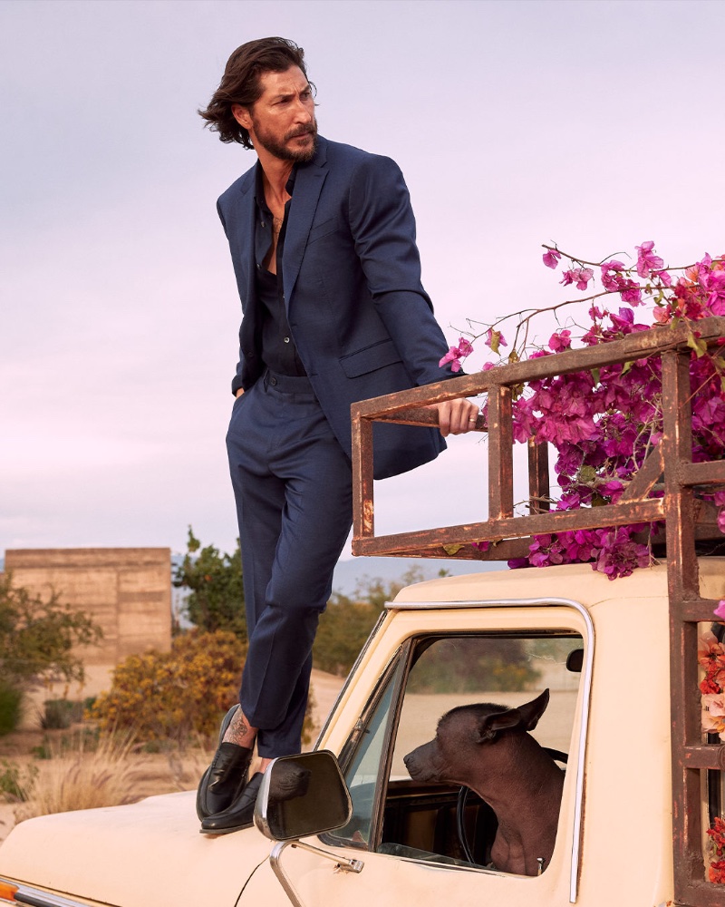 Ryan Porter models a navy suit with a black shirt for Banana Republic's summer 2023 campaign. 