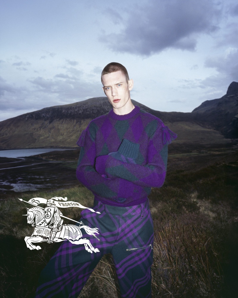 Wearing purple, Jake Hodder makes an appearance in Burberry's winter 2023 campaign. 