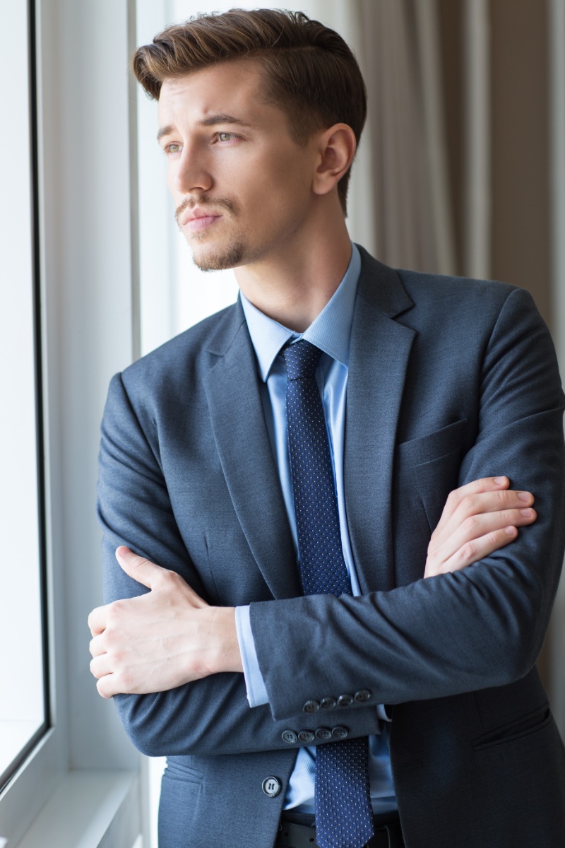 Royalty-Free photo: Man wearing blue suit jacket and dress pants standing  near road | PickPik