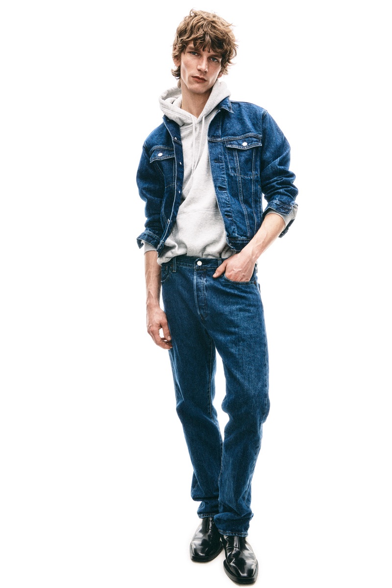 Embracing classic blue denim, Erik van Gils wears a jean jacket with a hoodie and jeans.