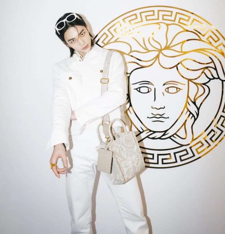 K-Pop star Hyunjin makes a splash in a Medusa Biggie denim jacket and jeans in white.