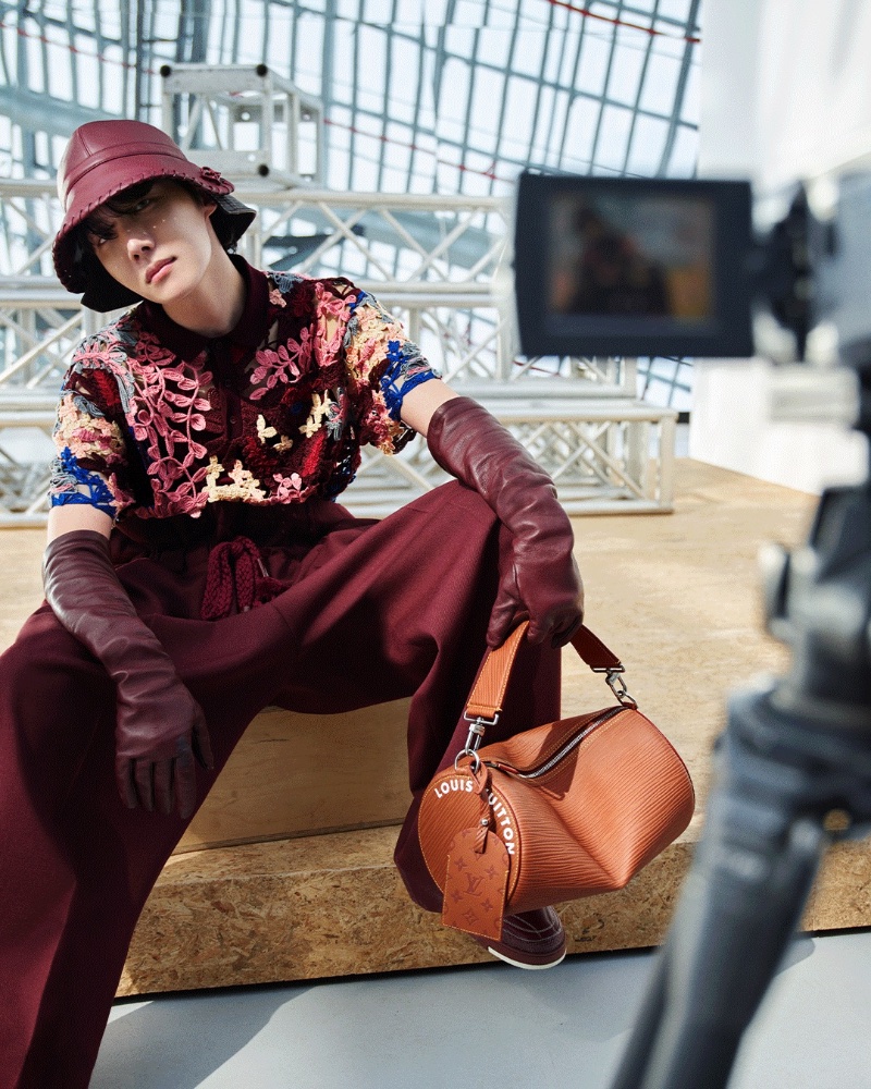 Embracing the softer side of menswear, J-Hope dons a crochet look for Louis Vuitton's fall-winter 2023 campaign. 
