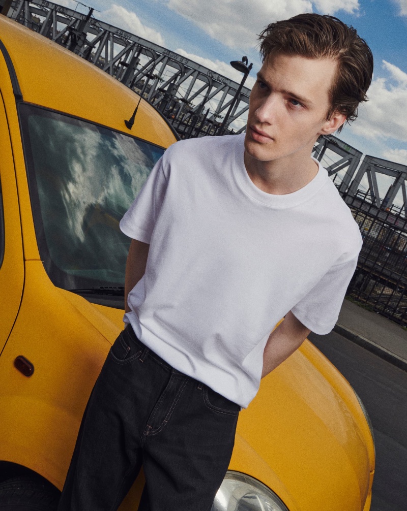 Embracing classic style, Joshua Thompson models a Massimo Dutti medium-weight t-shirt with tapered-fit jeans.