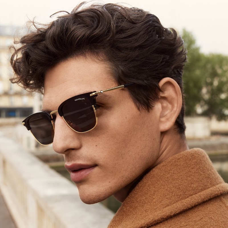 Pau Ramis models Montblanc rectangular sunglasses with a black colored injected frame. 