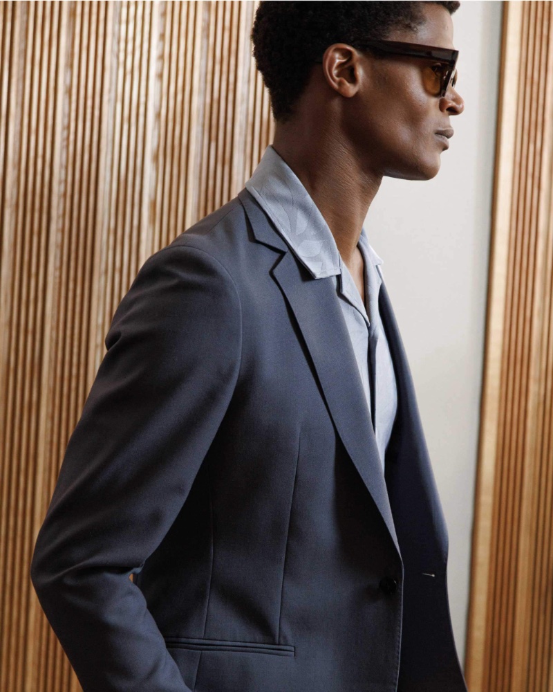 Model O'Shea Robertson dons a wool blazer with a printed Cuban-collared shirt.