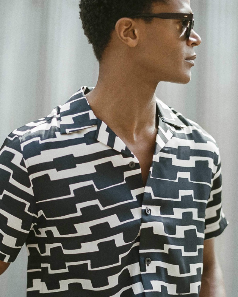 O'Shea Robertson models a graphic black and white Cuban-collared shirt. 