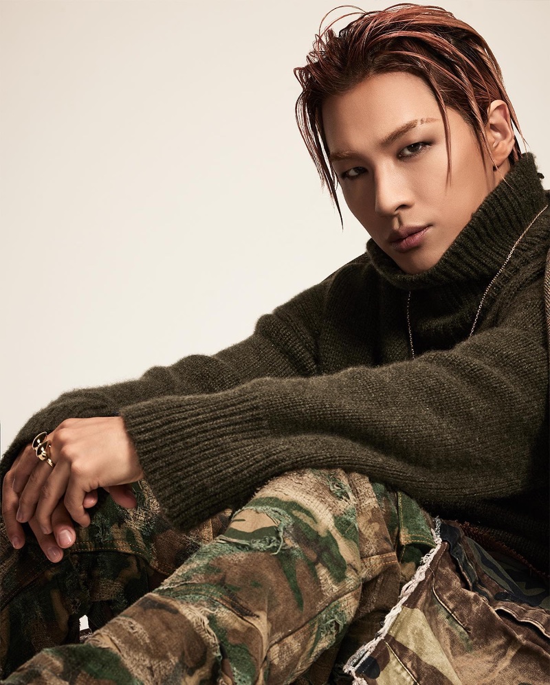 Sporting a turtleneck sweater with camouflage pants, Taeyang appears in Givenchy's fall-winter 2023 campaign. 