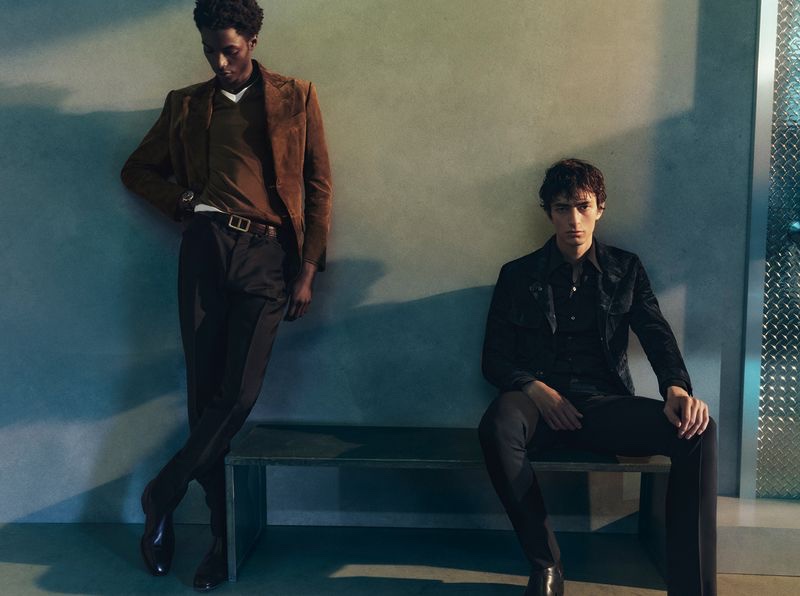 Models Ahmed Richards and Gena Malinin don neutral-colored tailoring for Tom Ford's pre-fall 2023 campaign. 