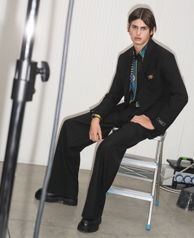 A sleek vision in black tailoring, Mark Vanderloo Jr. fronts the Versace pre-fall 2023 campaign.