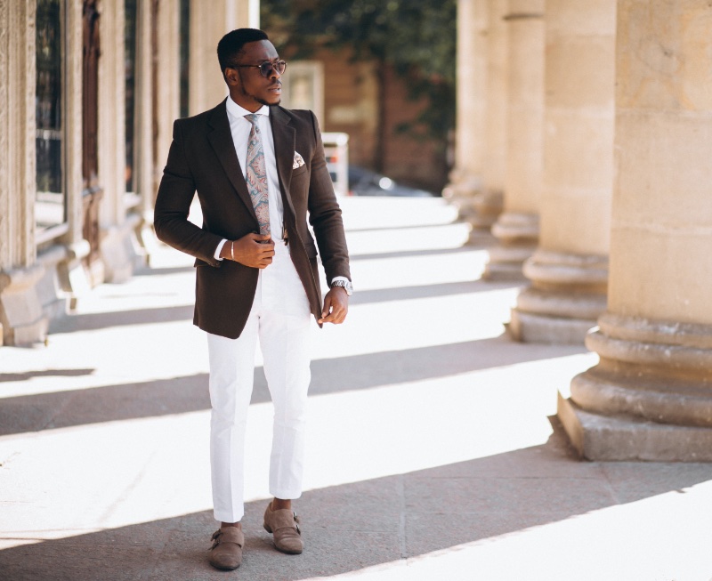 Premium Photo | White hoodie on man with brown pants in the city