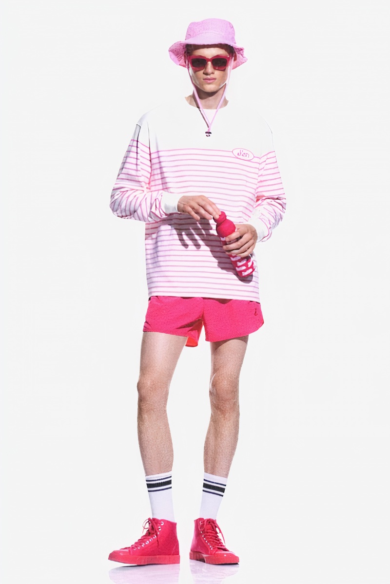 Dressed in head to toe pink, Braien Vaiksaar rocks a bucket hat with a striped long-sleeve top, shorts, and canvas high top sneakers. 