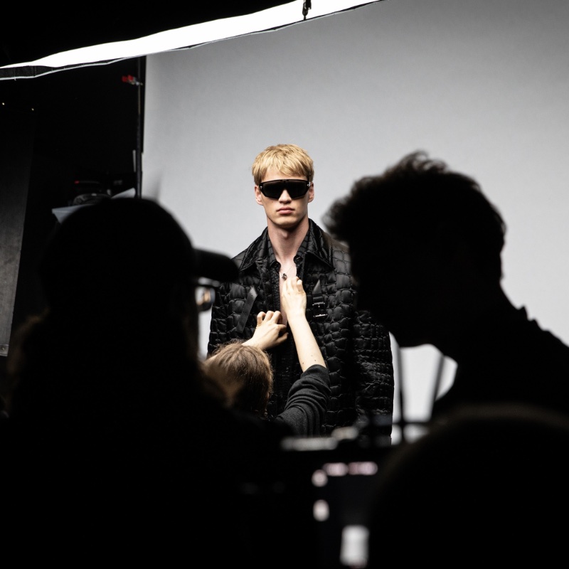 Filip Hrivnak takes the spotlight in this behind-the-scenes image from Versace's fall-winter 2023 campaign.