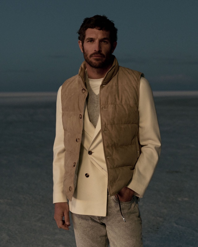 Layering for the season, Justice Joslin models a suede down vest with a double-breasted blazer, cashmere knit vest, and 5-pocket trousers.