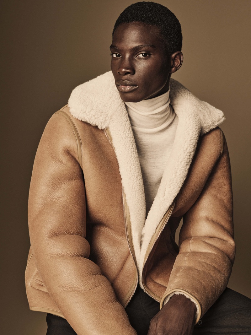 Dara Gueye sports a shearling jacket over a turtleneck for COS' fall-winter 2023 campaign.