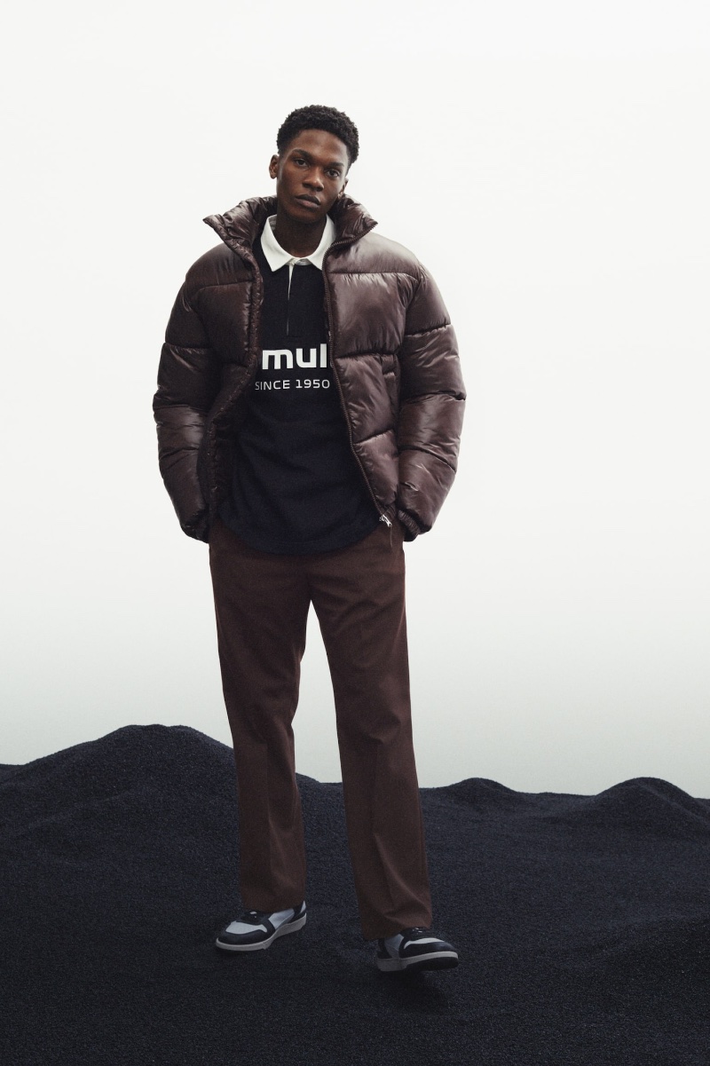 Tapping into a Street vibe, Odinaka Ekezie models a H&M polo shirt with a puffer jacket, flared pants, and basketball sneakers.