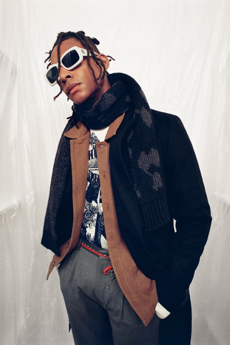 Wearing a scarf and white sunglasses, Ty Ogunkoya fronts HUGO's fall-winter 2023 campaign. 