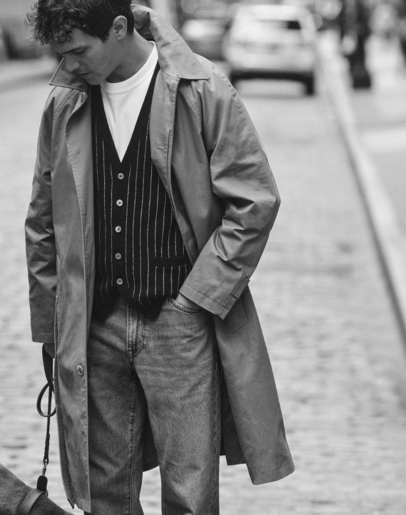 Taking to the streets, Vincent LaCrocq dons a J.Crew Ludlow trench coat, cashmere-blend sweater-vest, and a relaxed premium-weight cotton tee. 