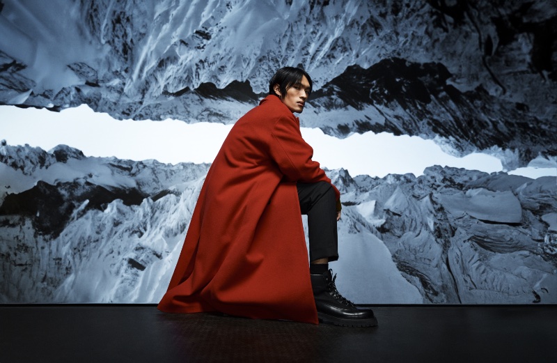 Jun Lai dons a long red coat for J.Lindeberg's fall-winter 2023 campaign.