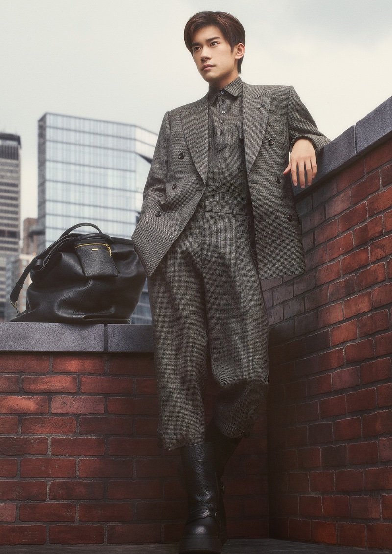 An elegant vision, Jackson Yee dons tailoring for Emporio Armani's fall-winter 2023 campaign. 