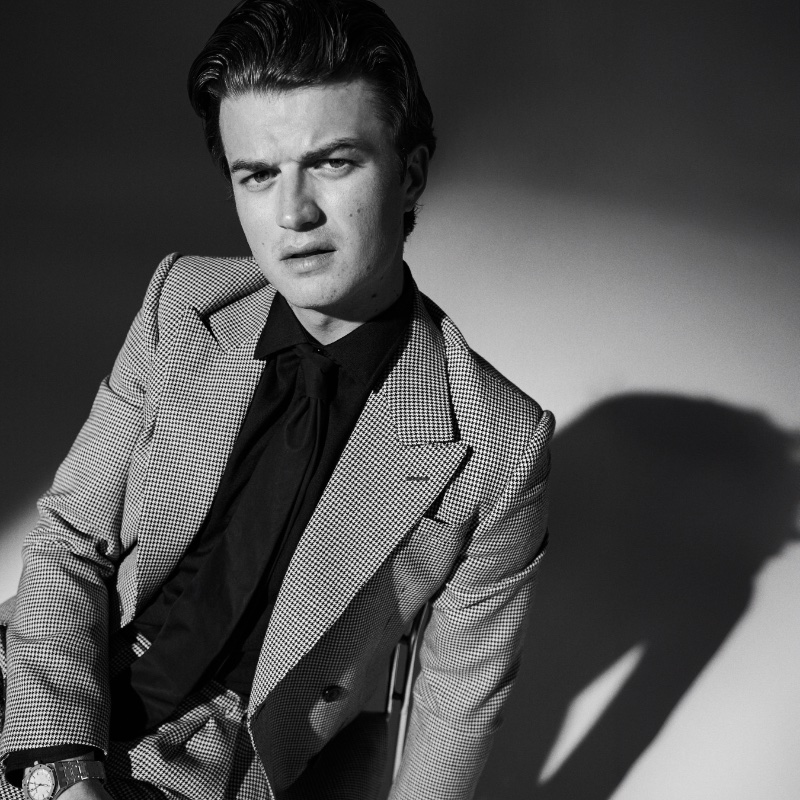 In the spotlight, Joe Keery dons an Alexander McQueen suit, Celine shirt, Ferragamo tie, and Audemars Piguet watch for WWD Weekend. 