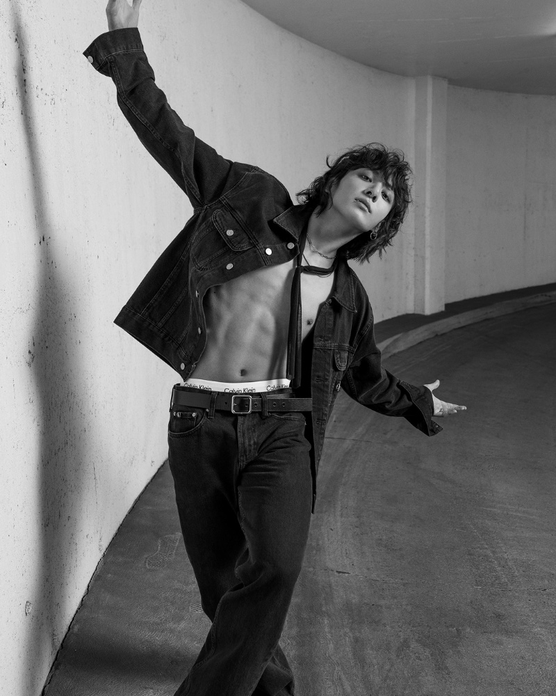 Embracing a carefree energy, Jung Kook sports a 90s denim trucker jacket with straight jeans for Calvin Klein's fall 2023 campaign.