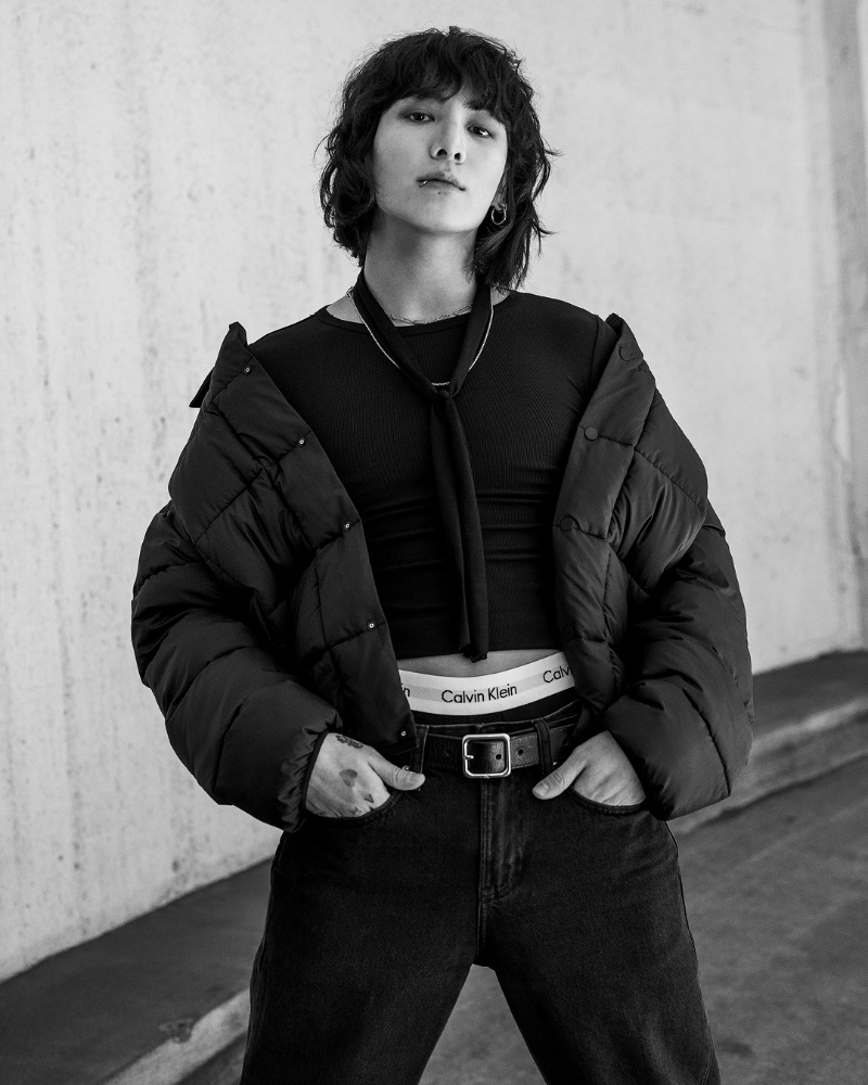 Returning for Calvin Klein's fall 2023 campaign, Jung Kook wears a padded lightweight jacket with a contour rib slim-fit t-shirt, 90s straight jeans, and Modern cotton stretch low rise trunk underwear.