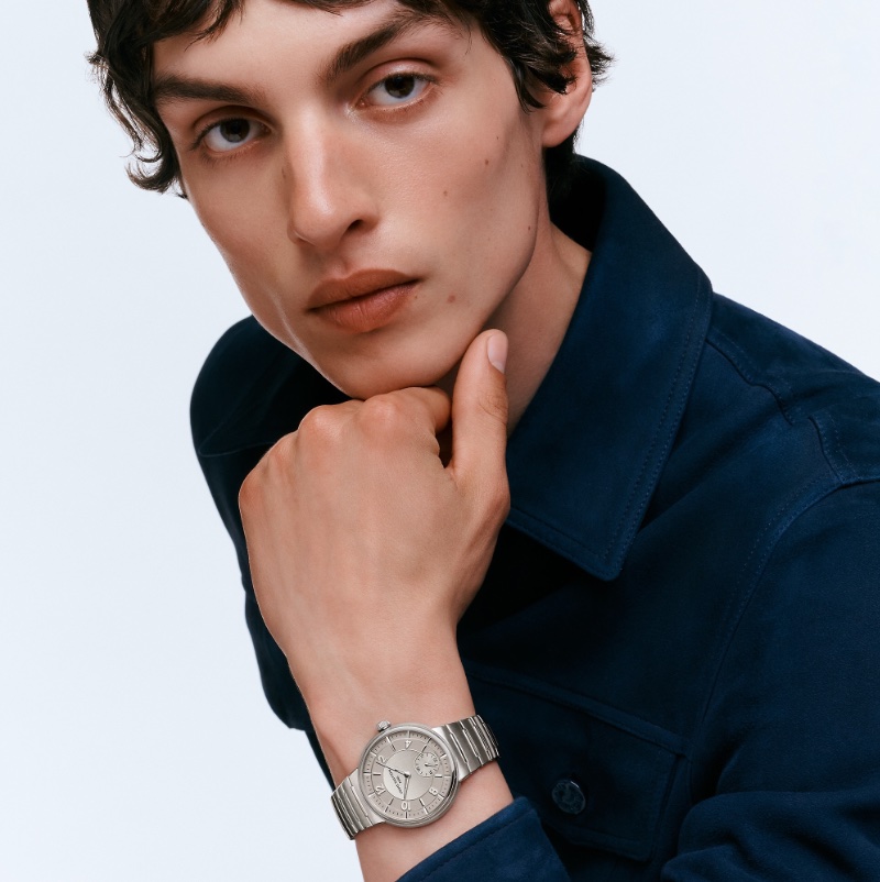 Model Lucas El Bali dons Louis Vuitton's Tambour automatic 40mm steel watch. 
