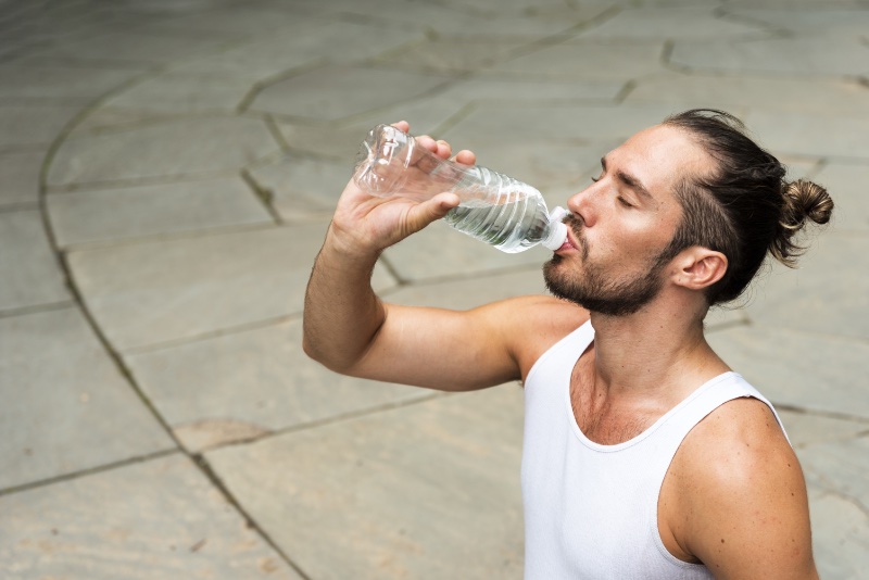 Man Drinking Water Outside Man Bun