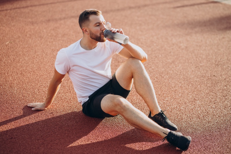 Man Field Drinking Water