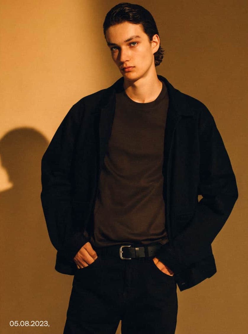 Embracing dark hues, Dante Scheck wears a denim overshirt with a relaxed-fit t-shirt and straight-fit jeans from the fall-winter 2023 Massimo Dutti Studio collection. 