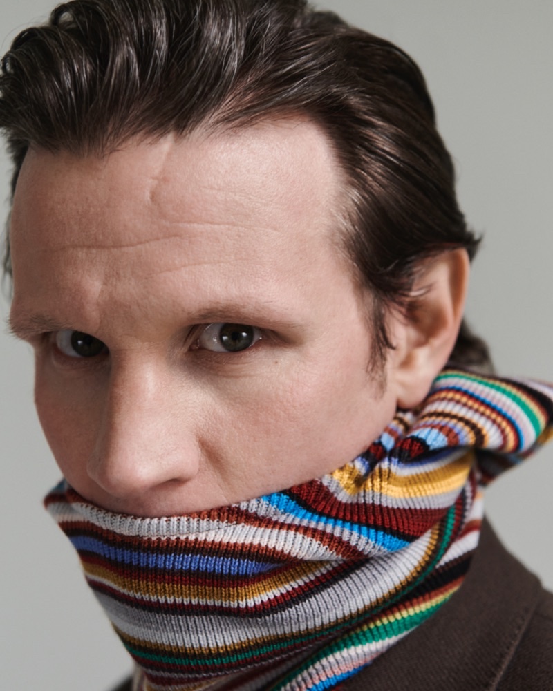 Donning one of Paul Smith's signature striped scarves, Matt Smith stars in the brand's fall-winter 2023 campaign. 