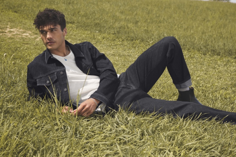 Model Laurence Coke relaxes in Marcus selvedge jeans for Mavi's fall-winter 2023 campaign.