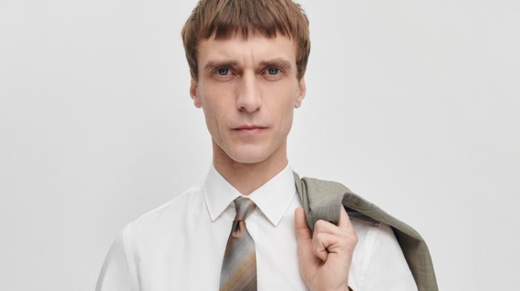 Dressed for business, Clément Chabernaud wears The Kensington grey and brown mini check wool suit with a brown silk ombre stripe tie by Paul Smith.