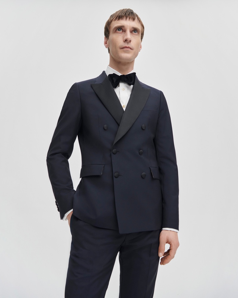 A dashing vision in Paul Smith, Clément Chabernaud models a a dark blue and black double-breasted tuxedo jacket with a velvet bowtie.