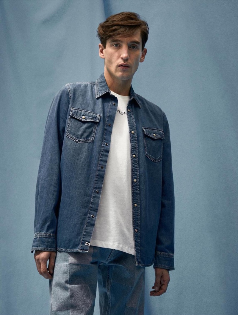 Anatol Modzelewski wears a Pepe Jeans snap button denim shirt with patchwork jeans.