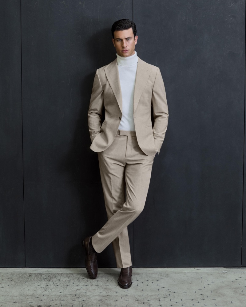 Mattia Narducci models a REISS slim-fit wool-blend suit with a turtleneck sweater.