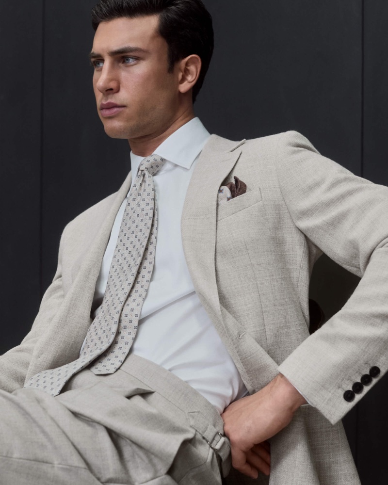 A chic vision in a stone color, Mattia Narducci goes sartorial in a suit, shirt, and tie.