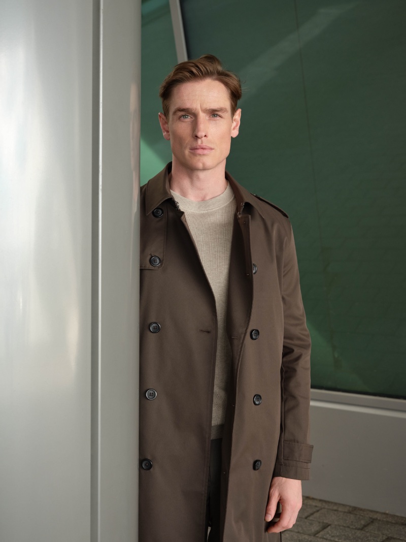Patrick O'Donnell wears a plain sweater with a short trench coat by Reserved. 