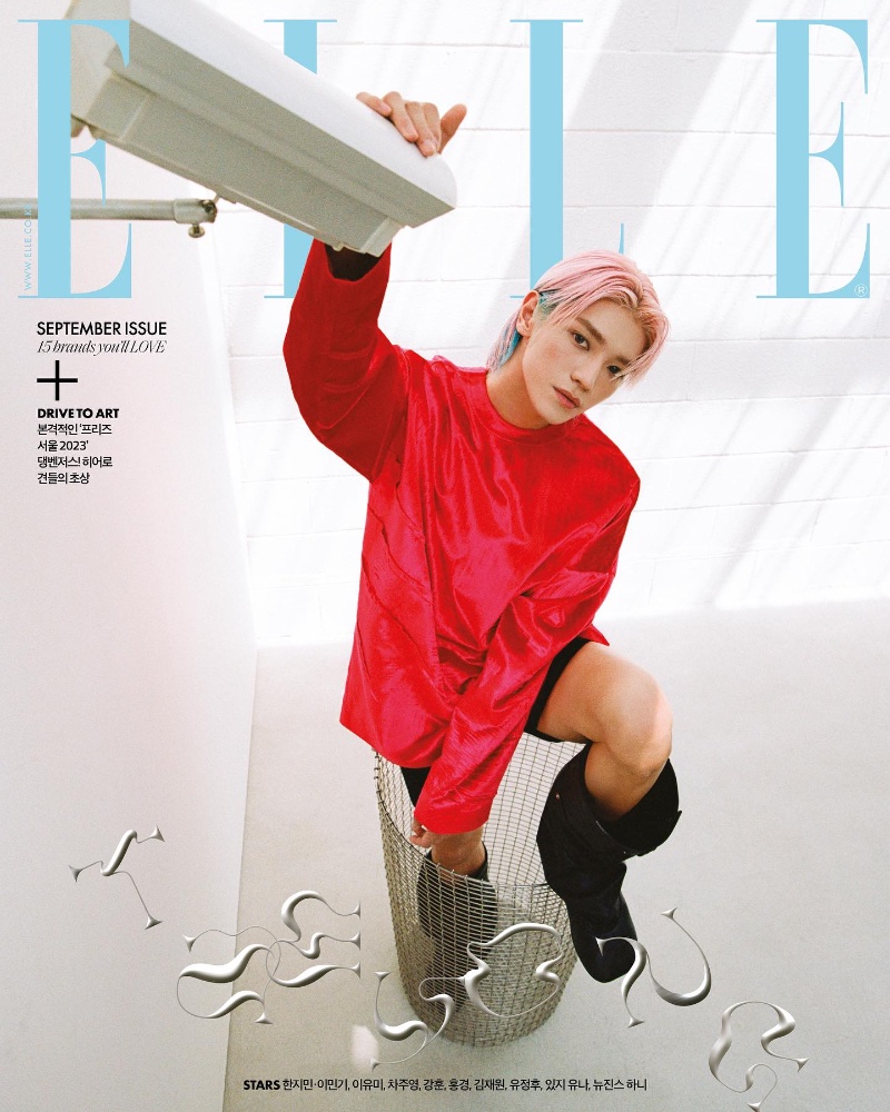 Taeyong covers Elle Korea's September 2023 issue in a red top, shorts, and boots by Loewe.