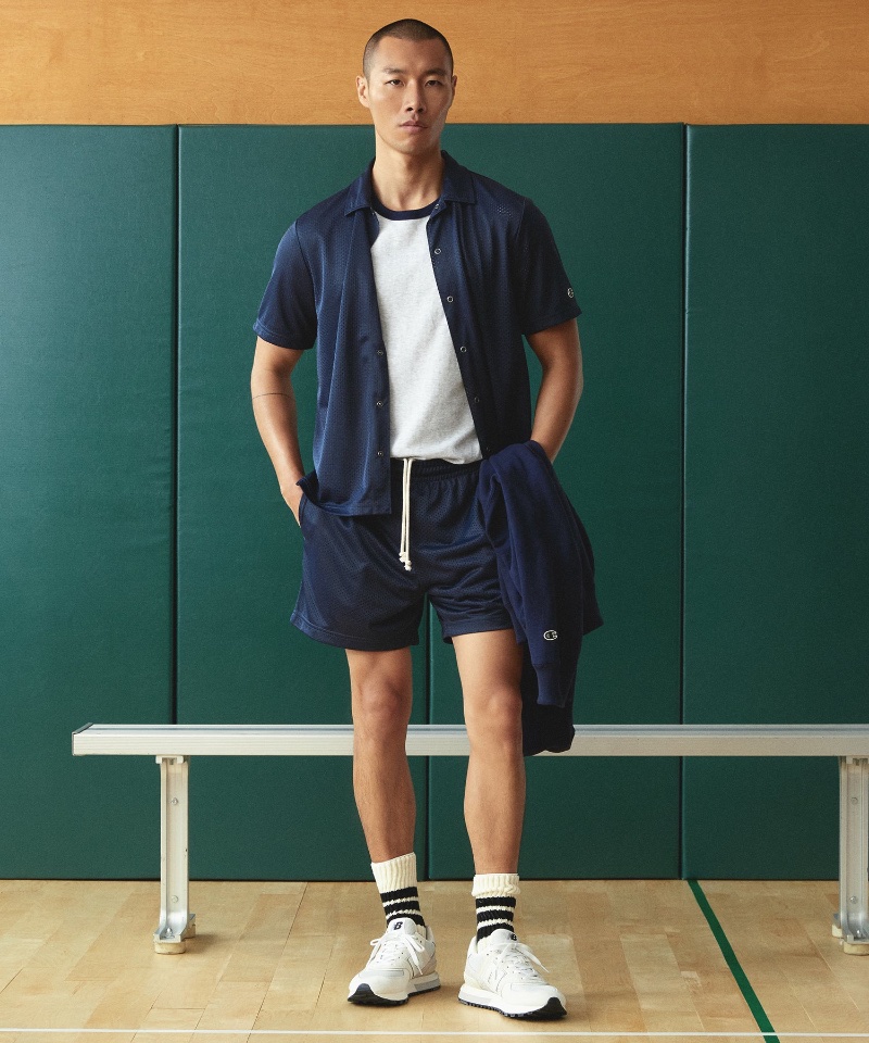 Gun Lee sports a Todd Snyder + Champion navy mesh shirt and shorts with a ringer tee. 