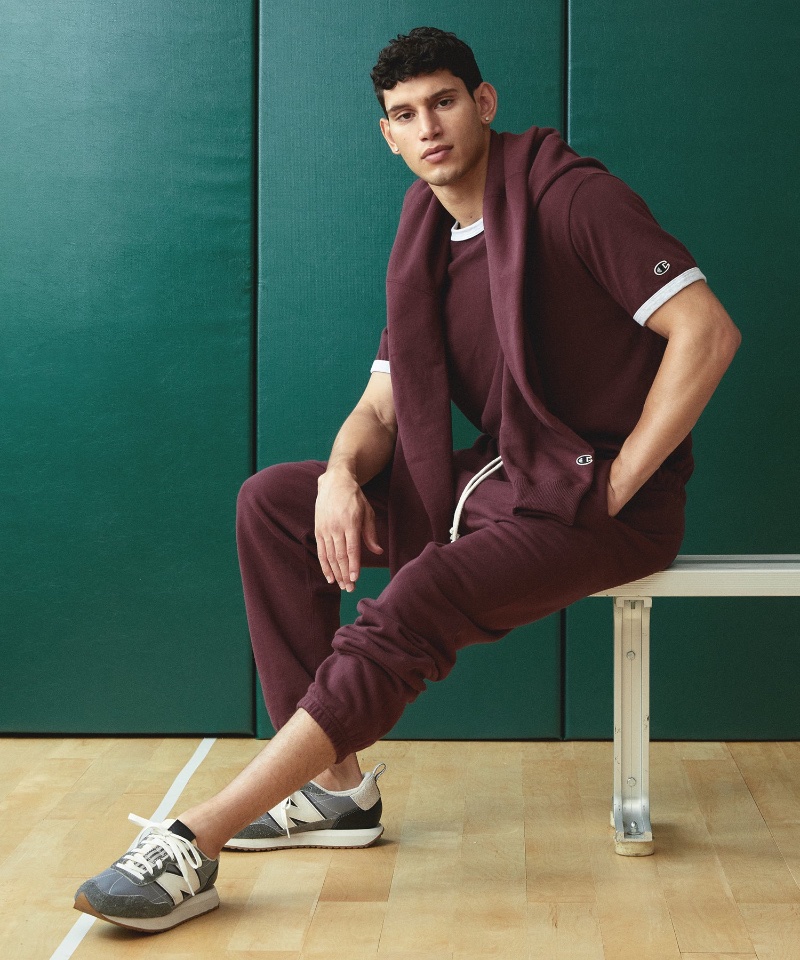 Embracing sporty style, Alexis Chaparro wears a Todd Snyder + Champion ringer tee, hoodie, and sweatpants in burgundy. 