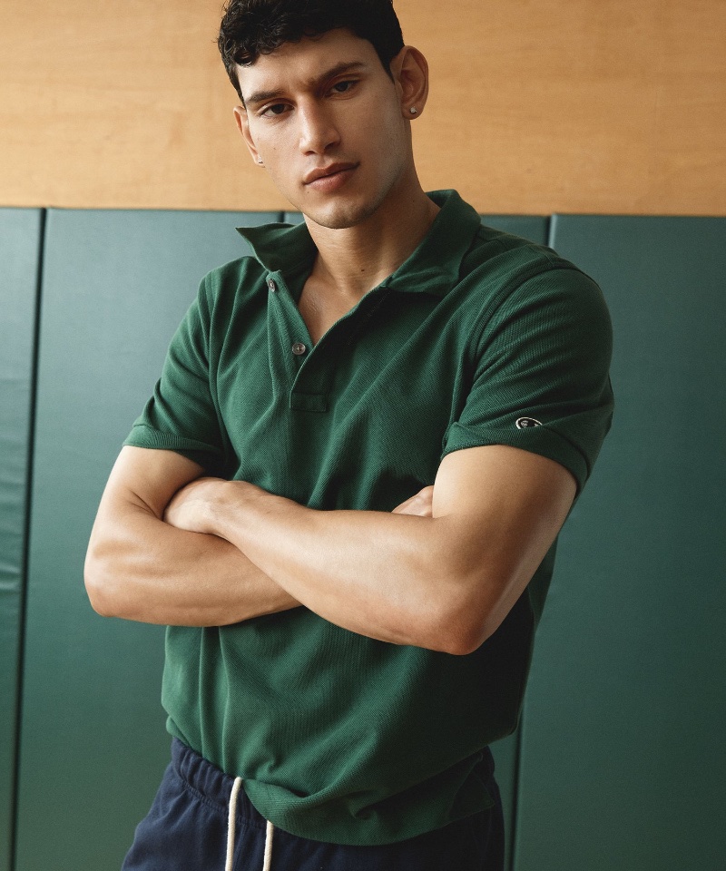 Channeling a sporty preppy vibe, Alexis Chaparro dons a green heavy pique polo from the Todd Snyder + Champion fall-winter 2023 collection.
