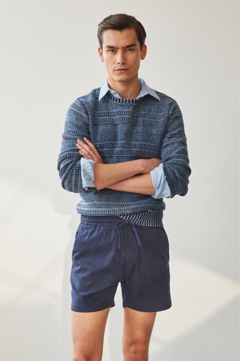 Embracing transitional style, Takezo wears a Todd Snyder cotton indigo crew with a classic-fit poplin shirt and 7" weekend shorts. 